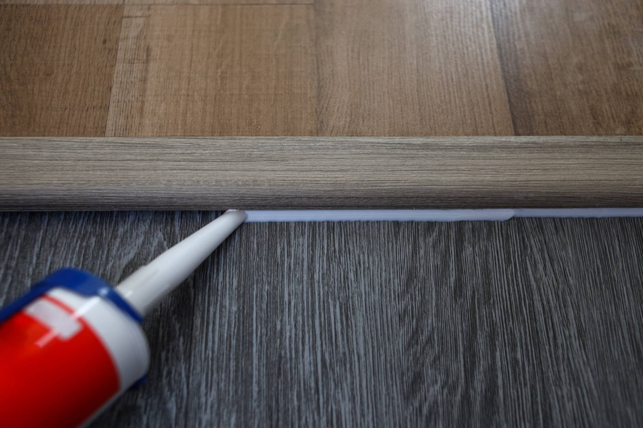 silicone-sealant-applying-silicone-caulking-wood-floor